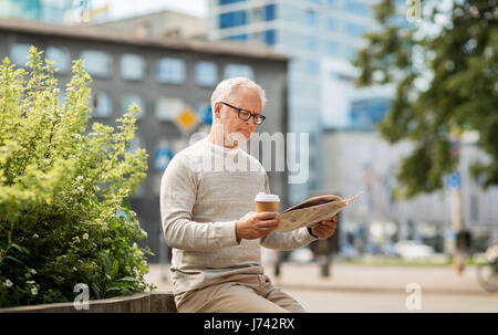 senior man reading newspaper and drinking coffee Stock Photo