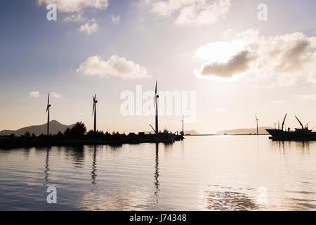 turbines at wind farm on sea shore Stock Photo