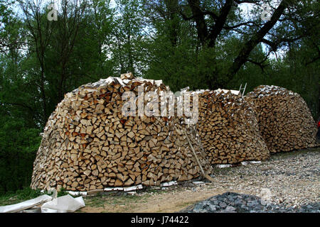 Three round large stack of firewood,wood for heating Stock Photo