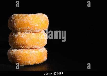 mini donuts sugar,sweet pieces of sugar doughnuts on black background, Copy space Stock Photo
