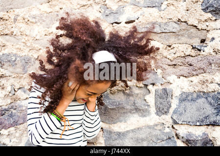 Beautiful african american girl with headphones, listening music. Stock Photo