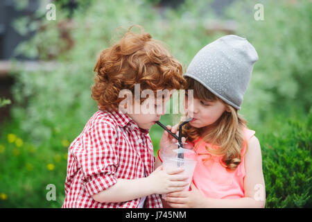 cute hipsters drinking cocktail in park Stock Photo