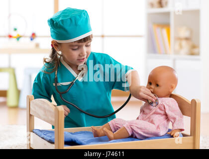 Child girl playing with doll in the hospital Stock Photo