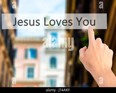 Jesus Loves You - Hand pressing a button on blurred background concept . Business, technology, internet concept. Stock Photo Stock Photo