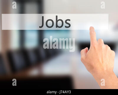 Jobs - Hand pressing a button on blurred background concept . Business, technology, internet concept. Stock Photo Stock Photo