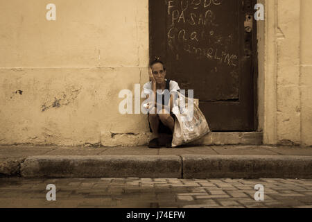 Elderly lady in alone in the street in Havana, Cuba Stock Photo