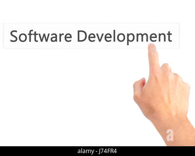 Software Development - Hand pressing a button on blurred background concept . Business, technology, internet concept. Stock Photo Stock Photo