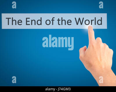 The End of the World - Hand pressing a button on blurred background concept . Business, technology, internet concept. Stock Photo Stock Photo