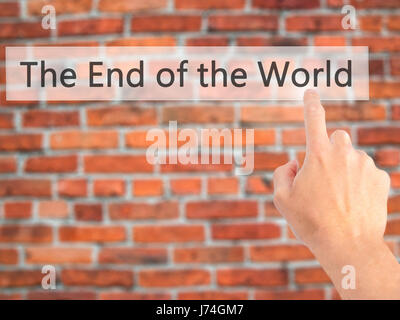 The End of the World - Hand pressing a button on blurred background concept . Business, technology, internet concept. Stock Photo Stock Photo