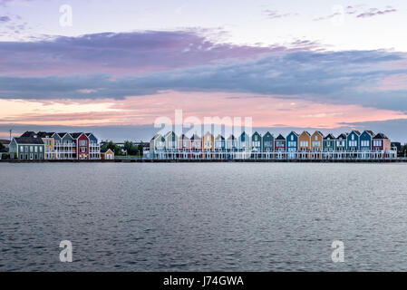 Houten, Netherlands - August 4, 2016: Calm evening at the famous Rainbow houses in the Netherlands. Colored wooden houses. Stock Photo