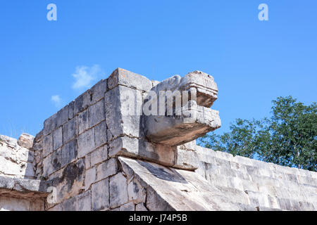 upward view of the stone jaguar head statue at the Platform of the Eagles and Jaguars in Mayan Ruins of Chichen Itza, Mexico Stock Photo