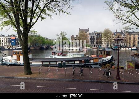 AMSTERDAM, NETHERLANDS - MAY, 13, 2017: The city on a cloudy spring day Stock Photo