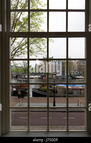 AMSTERDAM, NETHERLANDS - MAY, 13, 2017: View of the city of Amsterdam through a window Stock Photo