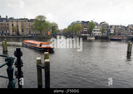 AMSTERDAM, NETHERLANDS - MAY 13, 2017: The city on a cloudy spring day Stock Photo