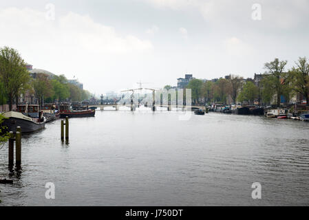 AMSTERDAM, NETHERLANDS - MAY, 13, 2017: The city on a cloudy spring day Stock Photo