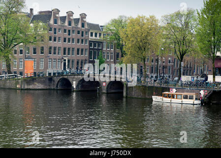 AMSTERDAM, NETHERLANDS - MAY, 13, 2017: The city on a cloudy spring day Stock Photo