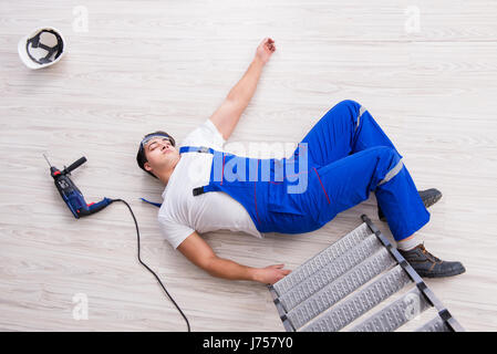 Worker after falling from height - unsafe behavior Stock Photo