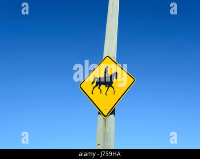 Yellow Roadside Sign warning of horseriders, New South Wales, NSW, Australia Stock Photo