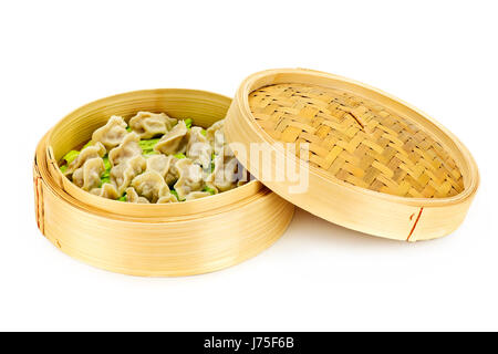 traditional bamboo steamer steamed dumplings food aliment isolated leaves round Stock Photo