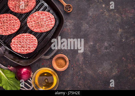 Raw beef cutlets on grill pan Stock Photo