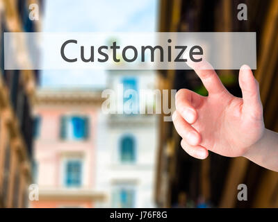 Customize - Hand pressing a button on blurred background concept . Business, technology, internet concept. Stock Photo Stock Photo