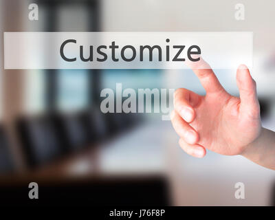 Customize - Hand pressing a button on blurred background concept . Business, technology, internet concept. Stock Photo Stock Photo