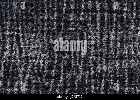Dark gray fluffy background of soft, fleecy cloth. Texture of black plush furry textile, closeup. Stock Photo
