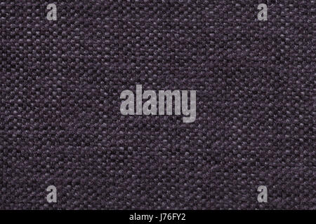 Dark violet knitted woolen background with a pattern of soft, fleecy cloth. Texture of purple textile closeup. Stock Photo