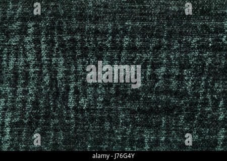 Dark green fluffy background of soft, fleecy cloth. Texture of emerald plush furry textile, closeup. Stock Photo