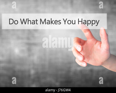 Do What Makes You Happy - Hand pressing a button on blurred background concept . Business, technology, internet concept. Stock Photo Stock Photo