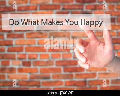 Do What Makes You Happy - Hand pressing a button on blurred background concept . Business, technology, internet concept. Stock Photo Stock Photo