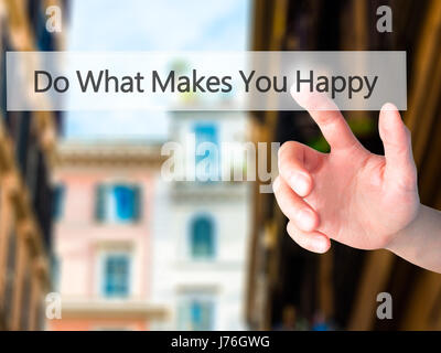 Do What Makes You Happy - Hand pressing a button on blurred background concept . Business, technology, internet concept. Stock Photo Stock Photo