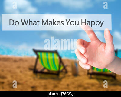 Do What Makes You Happy - Hand pressing a button on blurred background concept . Business, technology, internet concept. Stock Photo Stock Photo