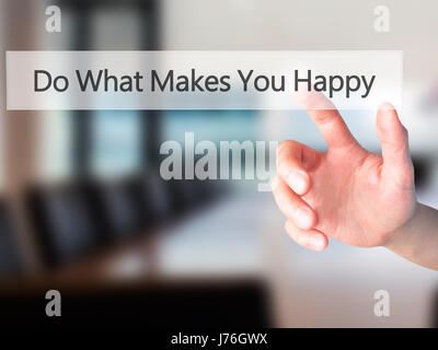 Do What Makes You Happy - Hand pressing a button on blurred background concept . Business, technology, internet concept. Stock Photo Stock Photo