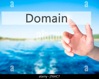 Domain - Hand pressing a button on blurred background concept . Business, technology, internet concept. Stock Photo Stock Photo
