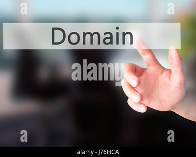 Domain - Hand pressing a button on blurred background concept . Business, technology, internet concept. Stock Photo Stock Photo