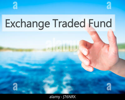 Exchange Traded Fund - Hand pressing a button on blurred background concept . Business, technology, internet concept. Stock Photo Stock Photo