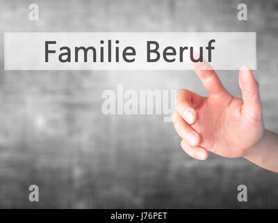 Familie Beruf (Family Occupation in German) - Hand pressing a button on blurred background concept . Business, technology, internet concept. Stock Pho Stock Photo