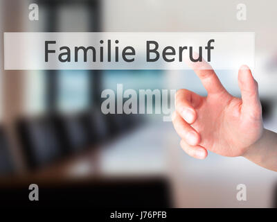 Familie Beruf (Family Occupation in German) - Hand pressing a button on blurred background concept . Business, technology, internet concept. Stock Pho Stock Photo