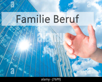 Familie Beruf (Family Occupation in German) - Hand pressing a button on blurred background concept . Business, technology, internet concept. Stock Pho Stock Photo