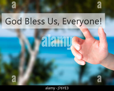 God Bless Us, Everyone - Hand pressing a button on blurred background concept . Business, technology, internet concept. Stock Photo Stock Photo