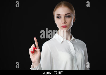 Business woman pointing at something on screen. Stock Photo