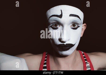 Portrait of a theatrical actor with mime makeup on a black background Stock Photo