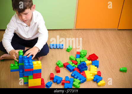 Little boy in a colorful room playing Stock Photo