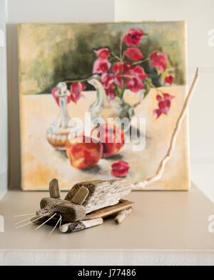 Driftwood mouse in front of a small still life painting Stock Photo