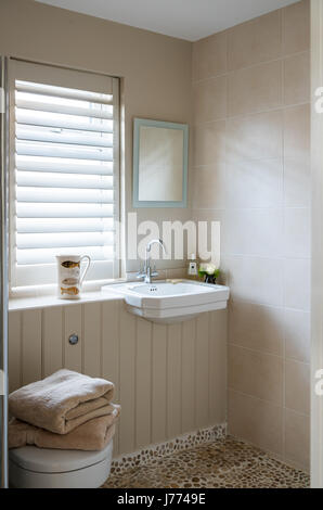 Pebble floor tiles from Marble Mosaics in en suite bathroom Stock Photo