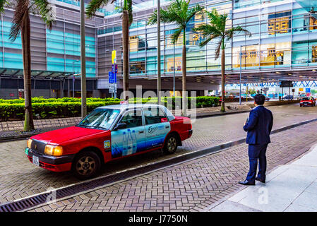 HONG KONG, CHINA - APRIL 25: This is a businessman waiting outside Hong Kong station on a rainy day in the downtown area on April 25, 2017 in Hong Kon Stock Photo