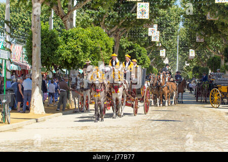 Seville, Spain - May 02, 2017: Traditional riding horse carriages celebrating Seville's April Fair. Stock Photo