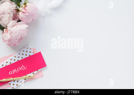 Beautiful, feminine flat lay with stationery and peonies, gold & pink, for blog, mock-up, lots of white space Stock Photo