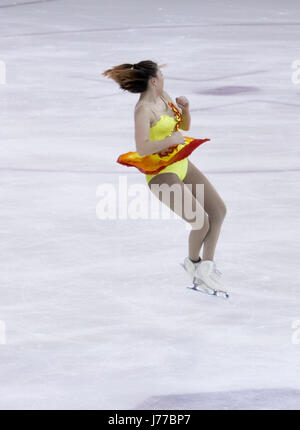 Figure skater performs a jump while competing Stock Photo